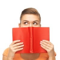Woman behind book