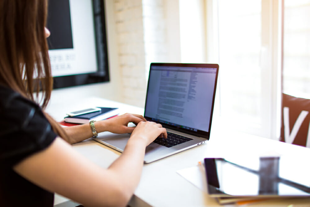 woman typing on a laptop