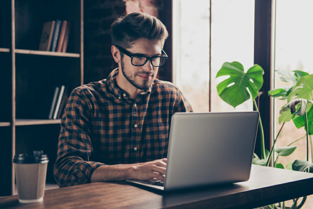 man typing on a laptop