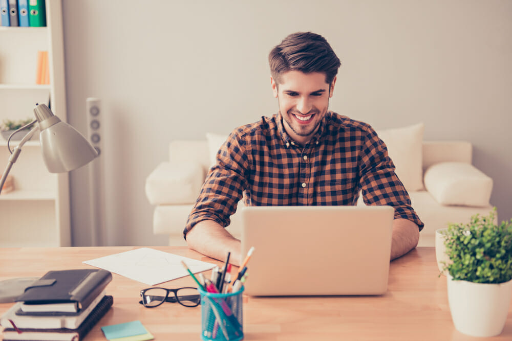 Man sitting in front of his laptop in an office.