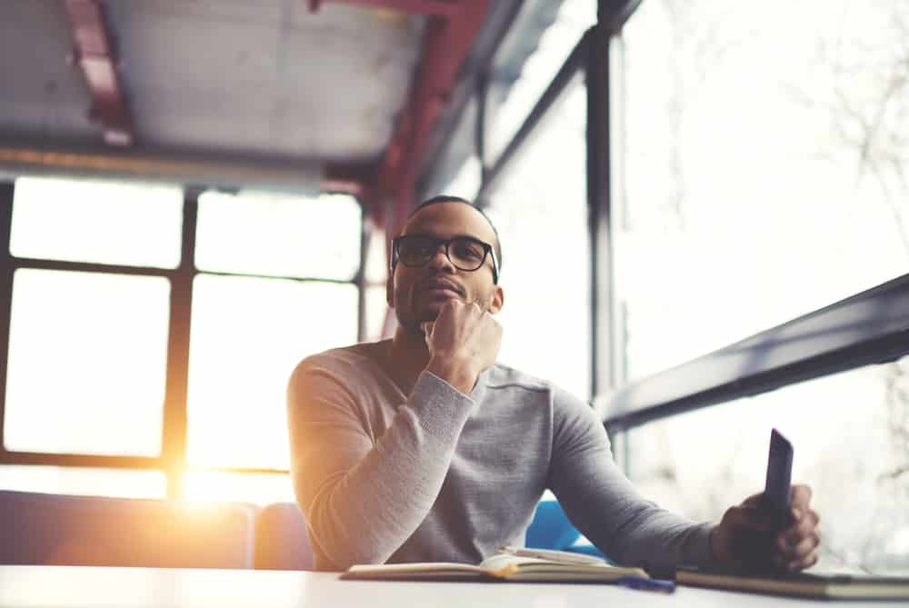 Man sitting at a desk thinking