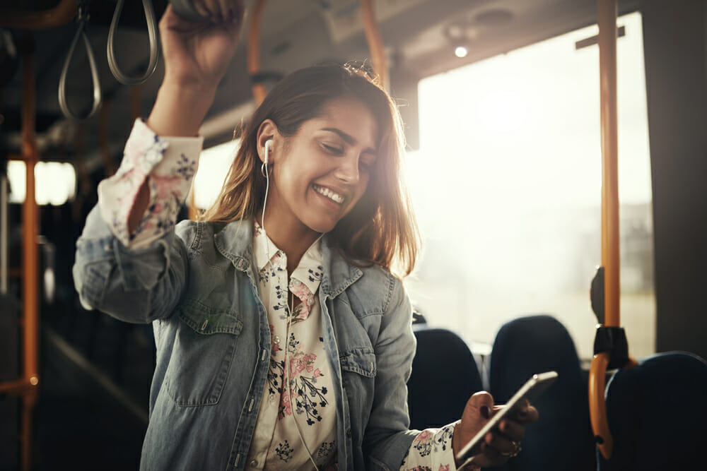 Woman with earbuds listening to music