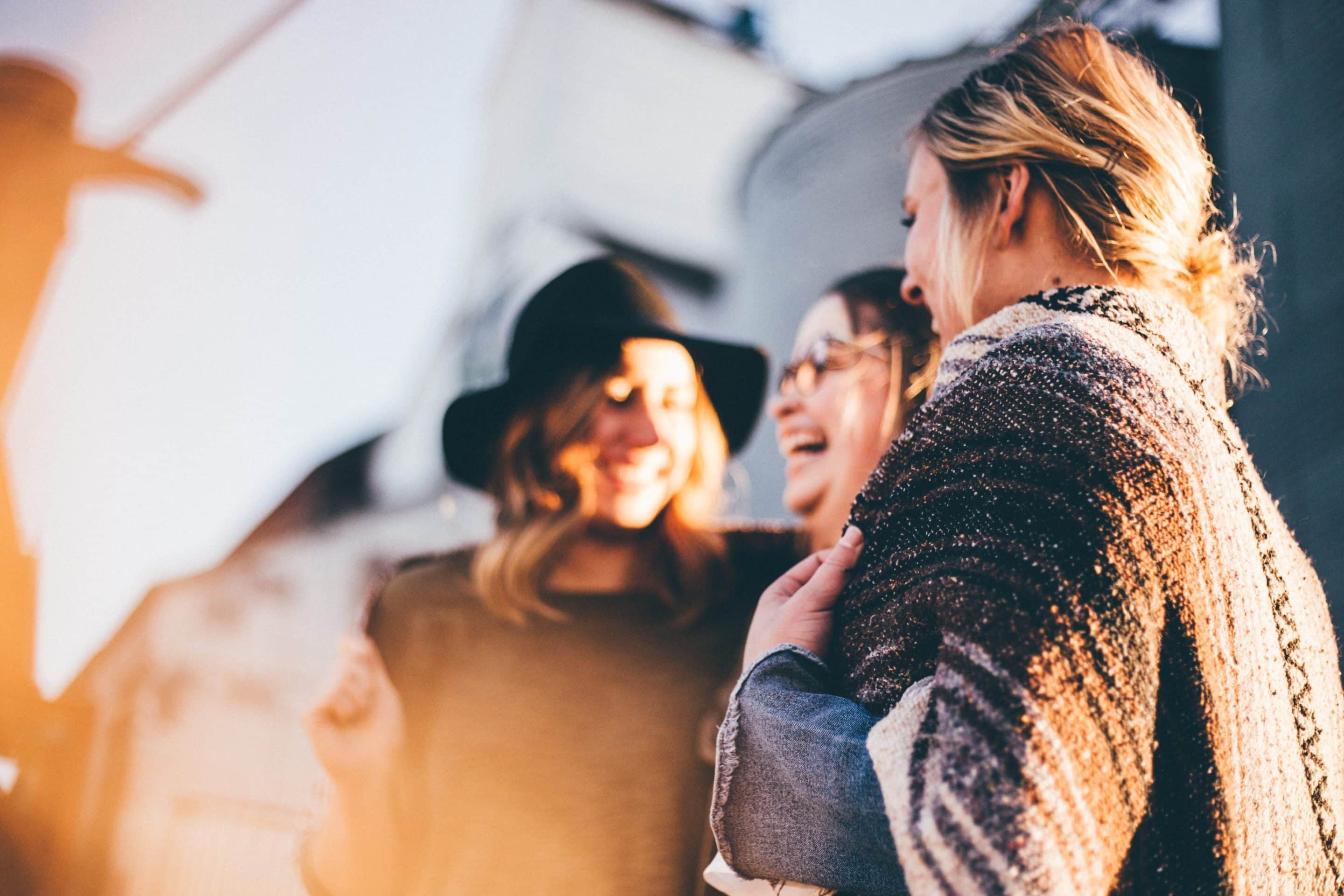 Group of people talking and laughing outside