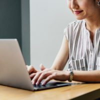 woman typing on a laptop