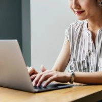 woman typing on a laptop