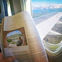 magazine story in front of an airplane window