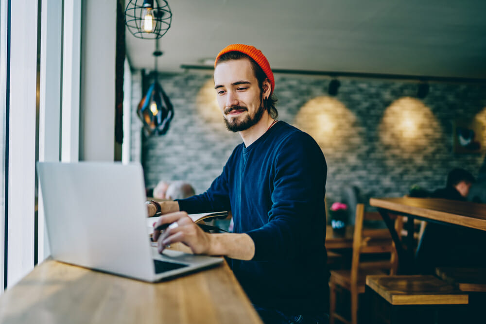 Man sitting in a cafe on his laptop