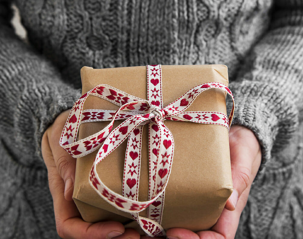 Woman holding a present with a bow