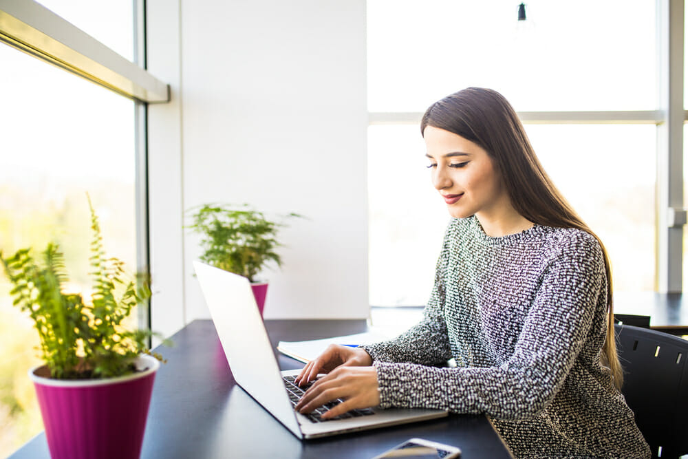 Woman sitting at a desk on her laptop