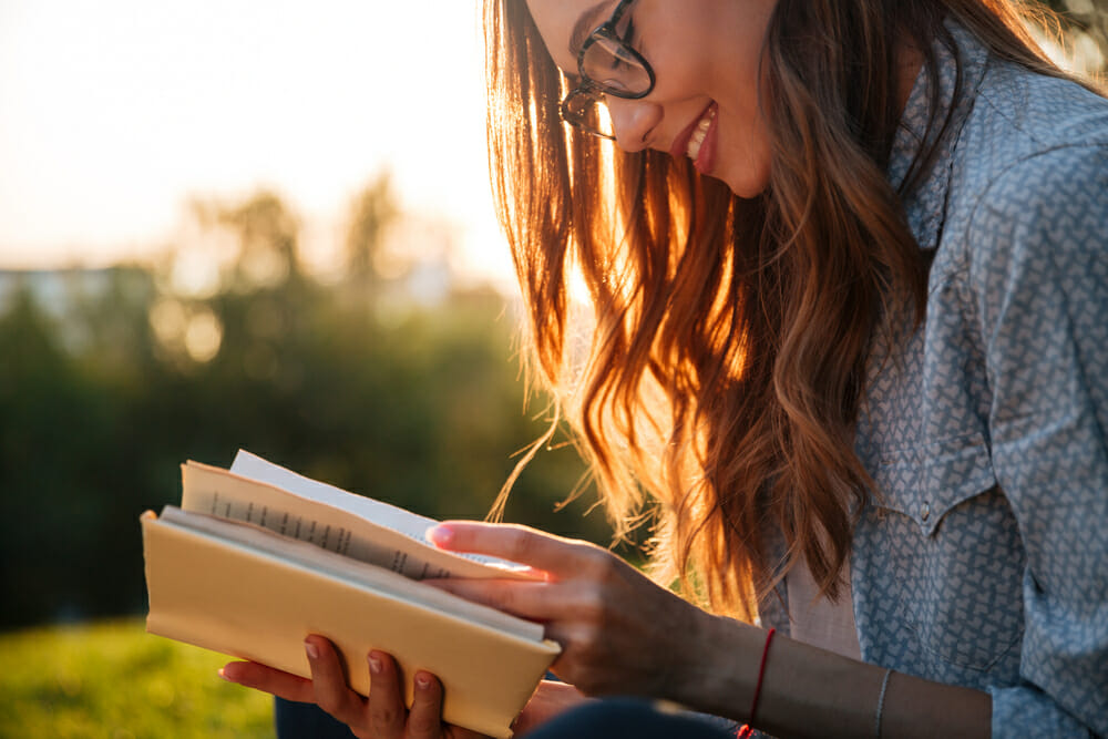 Woman reading a book outside