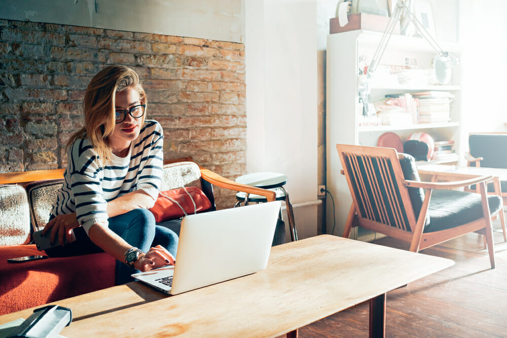 Woman sitting at a table on her laptop