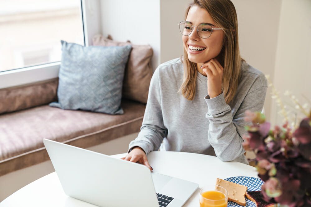 Woman sitting at a table with her laptop