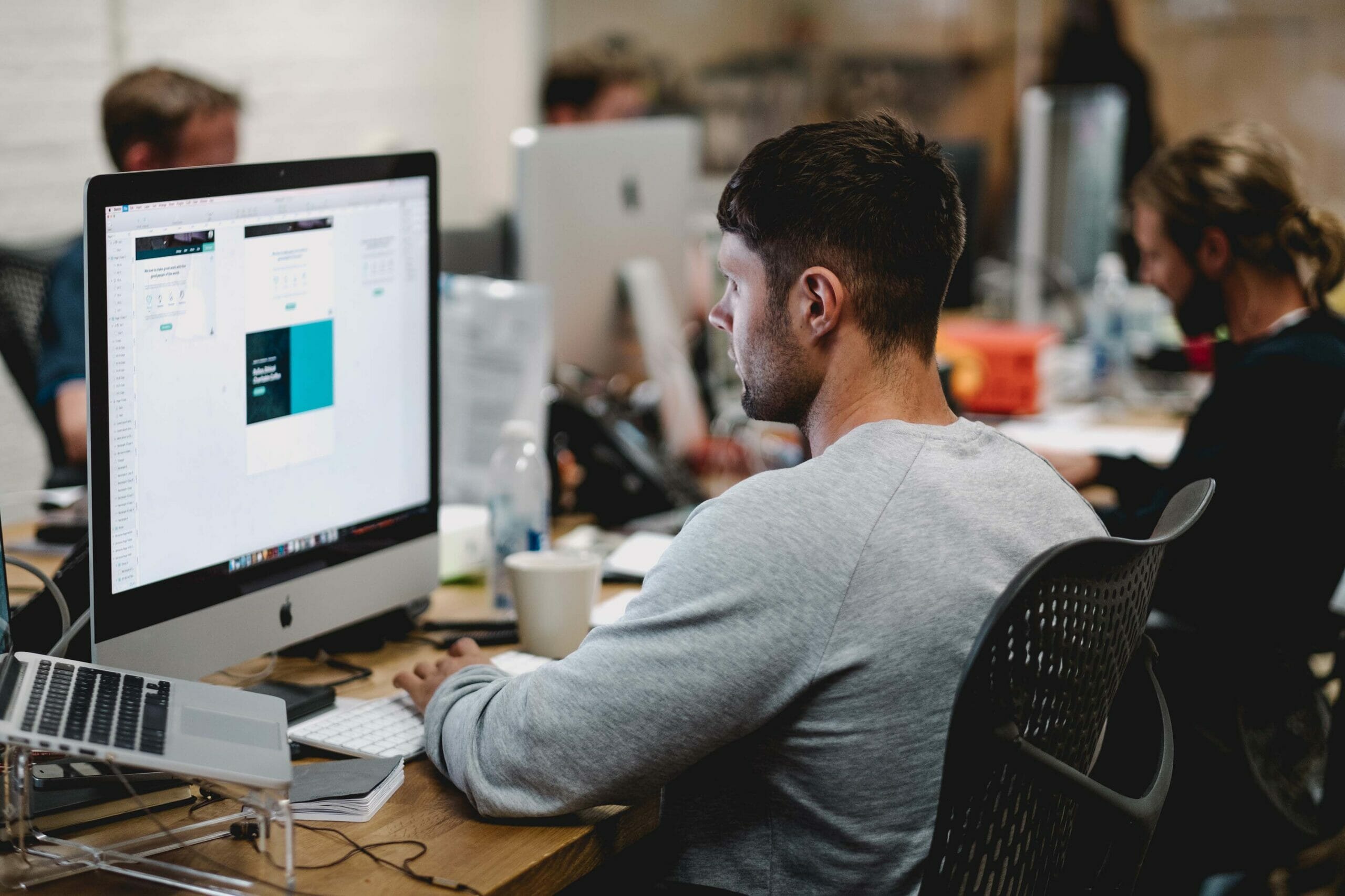 Man sitting at his computer looking at a design.