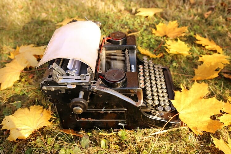 typewriter on ground with yellow leaves - nanowrimo goals